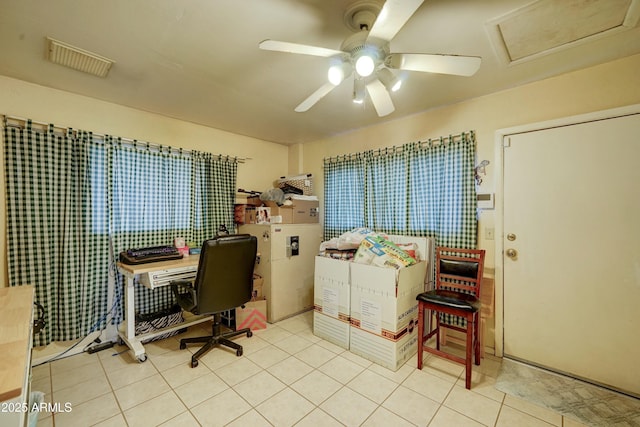 tiled home office featuring a ceiling fan and visible vents