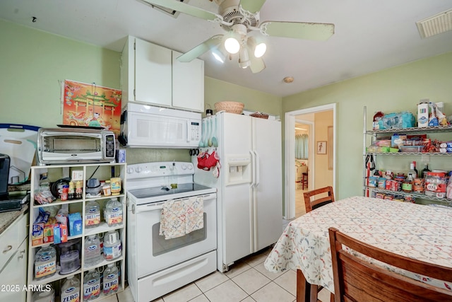 kitchen featuring white appliances, light tile patterned floors, visible vents, ceiling fan, and white cabinetry