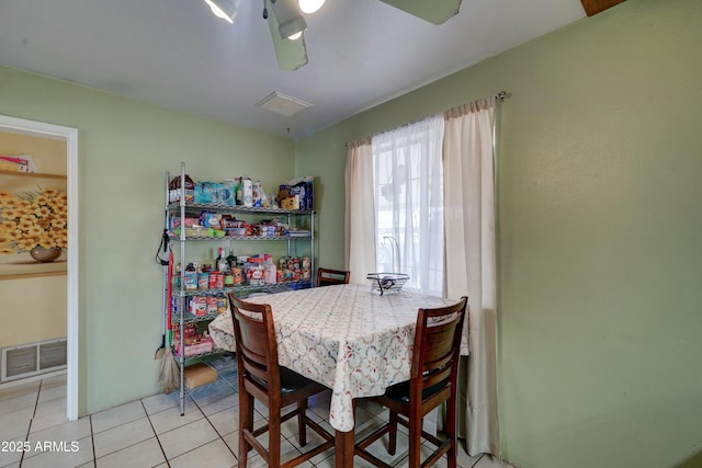 dining space featuring light tile patterned floors, visible vents, and ceiling fan