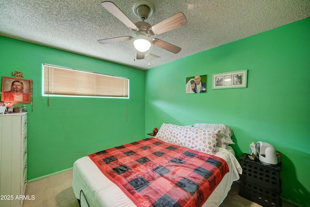 bedroom with visible vents, a ceiling fan, a textured ceiling, baseboards, and light colored carpet