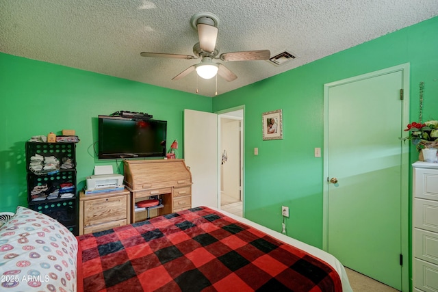 bedroom with a ceiling fan, visible vents, and a textured ceiling