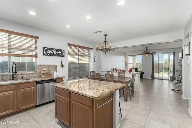 kitchen with dishwasher, a center island, hanging light fixtures, sink, and ceiling fan with notable chandelier