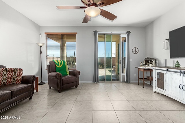 living room with ceiling fan and light tile patterned floors