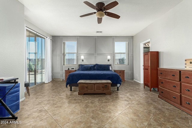 tiled bedroom featuring ceiling fan