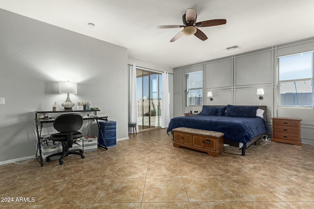 bedroom with ceiling fan, light tile patterned floors, and multiple windows