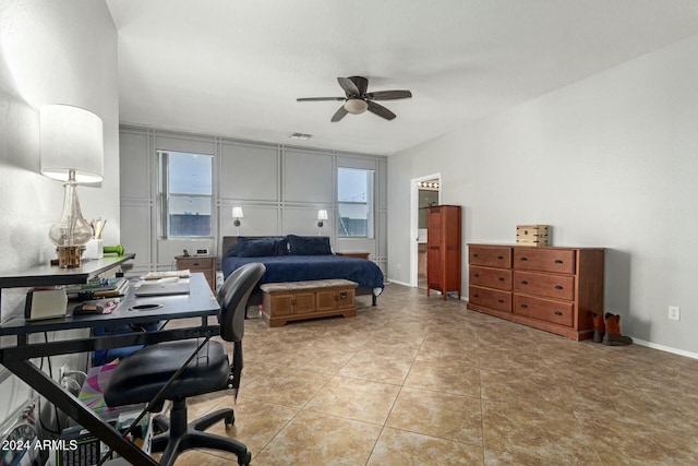 tiled bedroom featuring ceiling fan and multiple windows