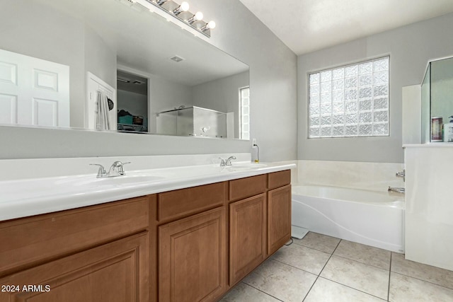 bathroom with tile patterned flooring, shower with separate bathtub, and vanity