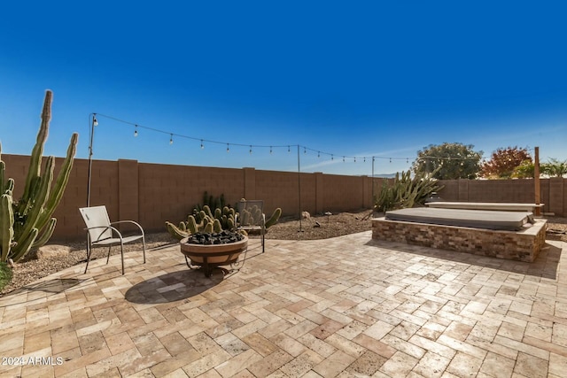 view of patio with a fire pit