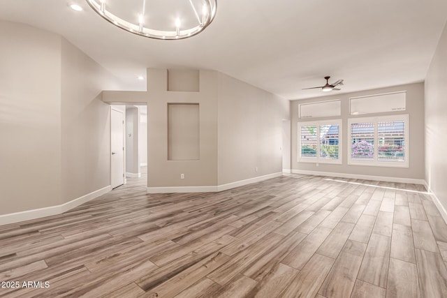 unfurnished living room with baseboards, ceiling fan, and light wood finished floors