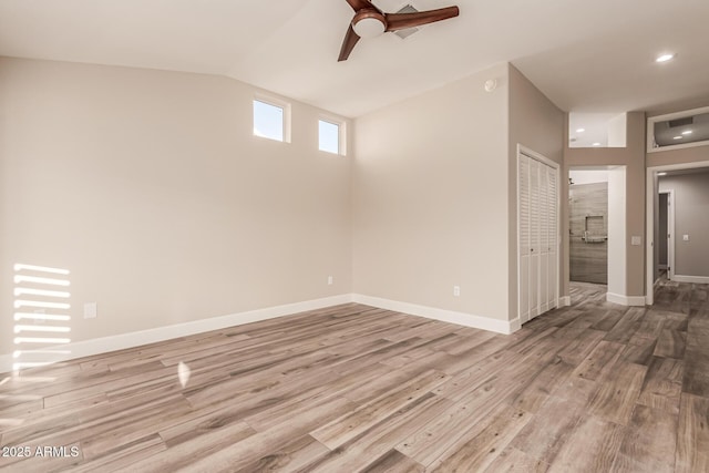 interior space with ceiling fan, recessed lighting, baseboards, wood finished floors, and lofted ceiling
