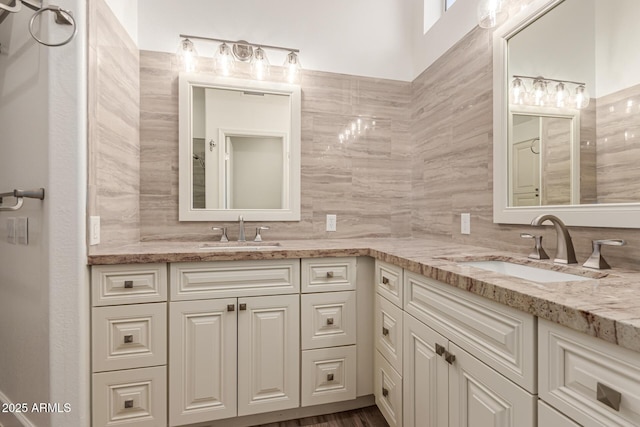 bathroom featuring double vanity, a sink, and tasteful backsplash