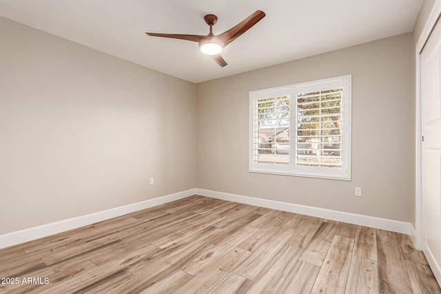 unfurnished room with a ceiling fan, baseboards, and light wood finished floors