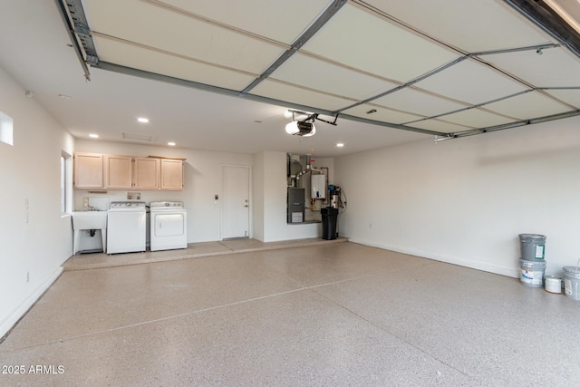 garage with recessed lighting, a garage door opener, baseboards, and washer and clothes dryer