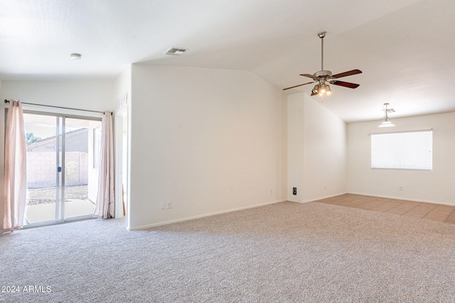 carpeted spare room with ceiling fan and vaulted ceiling