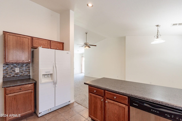 kitchen with white refrigerator with ice dispenser, pendant lighting, stainless steel dishwasher, decorative backsplash, and light tile patterned floors