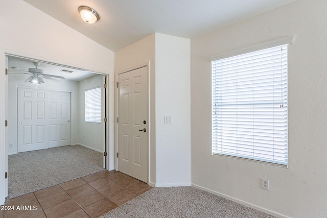 entrance foyer with lofted ceiling, light colored carpet, and ceiling fan