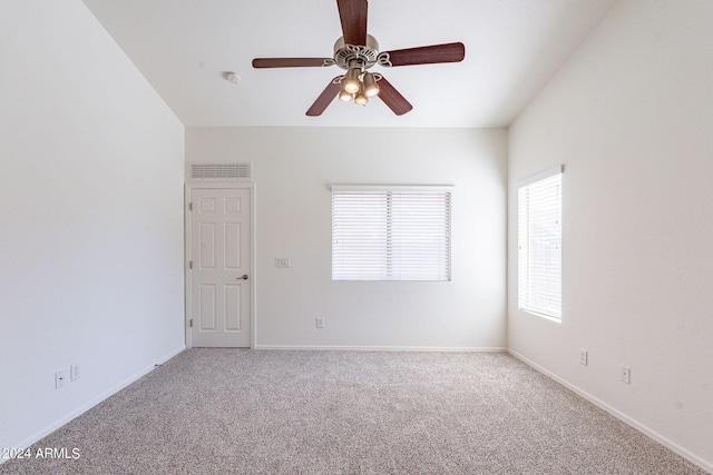 spare room featuring light colored carpet and ceiling fan