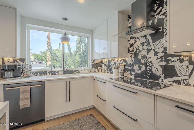 kitchen with tasteful backsplash, stainless steel dishwasher, white cabinetry, wall chimney exhaust hood, and black electric stovetop