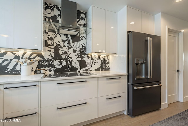 kitchen with fridge with ice dispenser, black electric cooktop, modern cabinets, and white cabinets