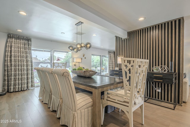 dining area featuring light wood finished floors, beam ceiling, and recessed lighting