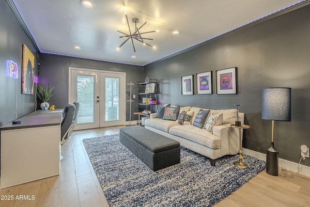 living room with french doors, baseboards, light wood-style flooring, and ornamental molding