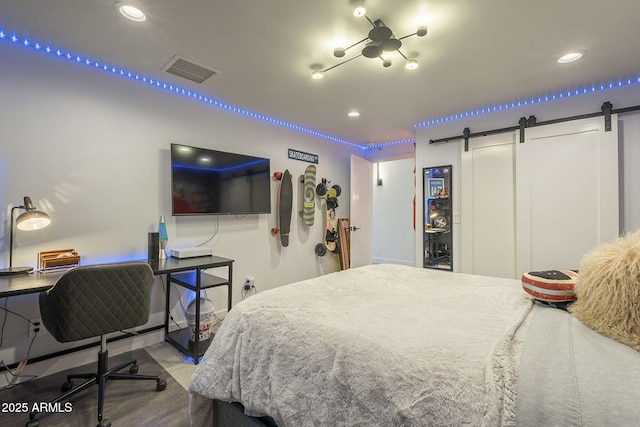 bedroom featuring recessed lighting, a barn door, and visible vents