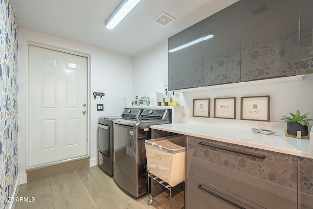 laundry area featuring washer and dryer, laundry area, light wood-style floors, and visible vents