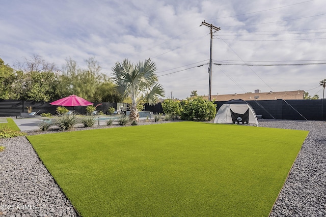view of yard featuring a fenced in pool, a patio, and a fenced backyard