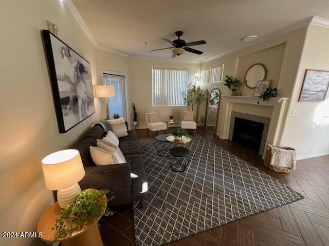 living room with ceiling fan, ornamental molding, and dark parquet floors