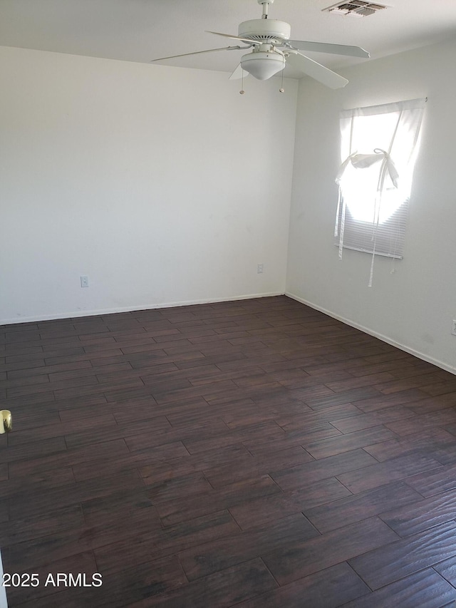 spare room featuring ceiling fan and dark wood-type flooring