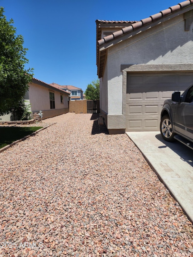 view of side of property with a garage