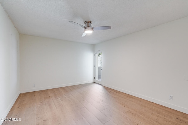 spare room featuring ceiling fan, a textured ceiling, and light hardwood / wood-style flooring