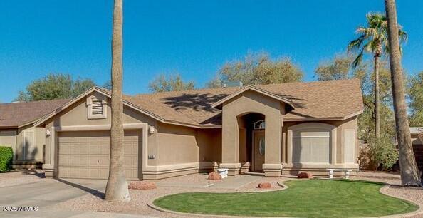 1688 E Krystal St, Casa Grande, AZ 85122 - ranch-style home with stucco siding, a garage, driveway, and a front yard