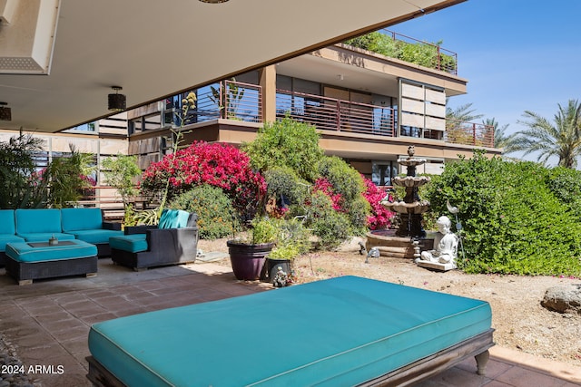 view of patio / terrace with a balcony and an outdoor living space