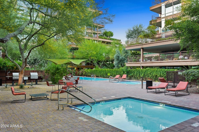 view of swimming pool with a patio