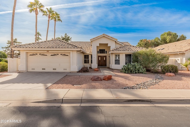 14543 W Bison Path, Surprise, AZ 85374 - view of front of home with stucco siding, a tiled roof, a garage, and concrete driveway