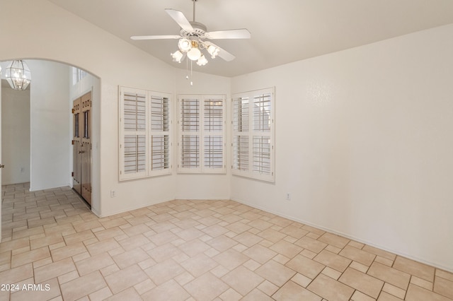 spare room with ceiling fan and vaulted ceiling