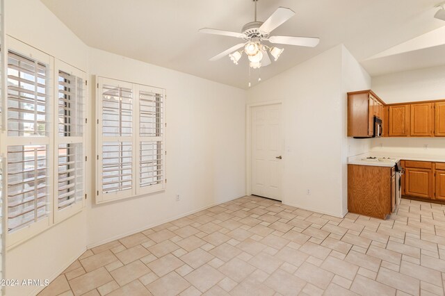 kitchen featuring ceiling fan, lofted ceiling, and appliances with stainless steel finishes