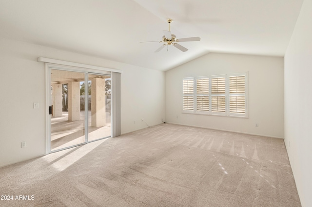 carpeted empty room featuring ceiling fan and vaulted ceiling