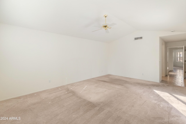 unfurnished room featuring light colored carpet, ceiling fan, and lofted ceiling