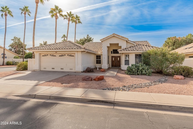 14543 W Bison Path, Surprise, AZ 85374 - view of front facade with stucco siding, a tile roof, an attached garage, and concrete driveway