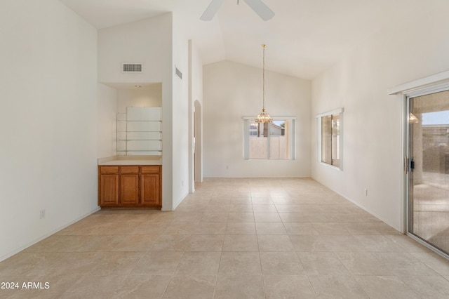 tiled spare room featuring ceiling fan and high vaulted ceiling