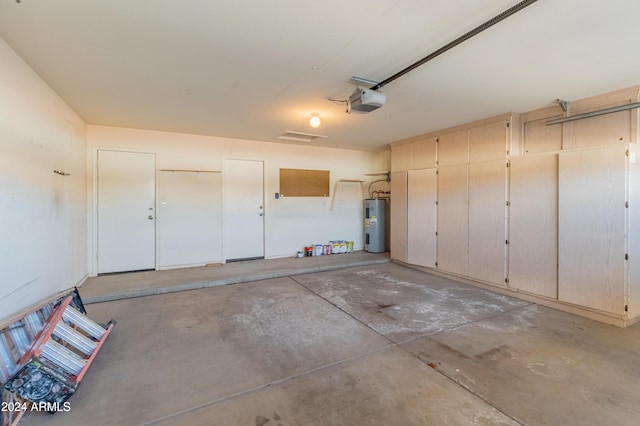 garage with electric water heater and a garage door opener