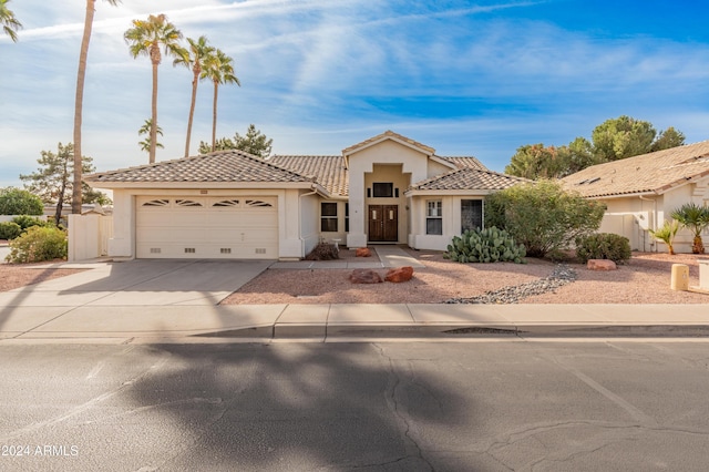 mediterranean / spanish-style home with a garage