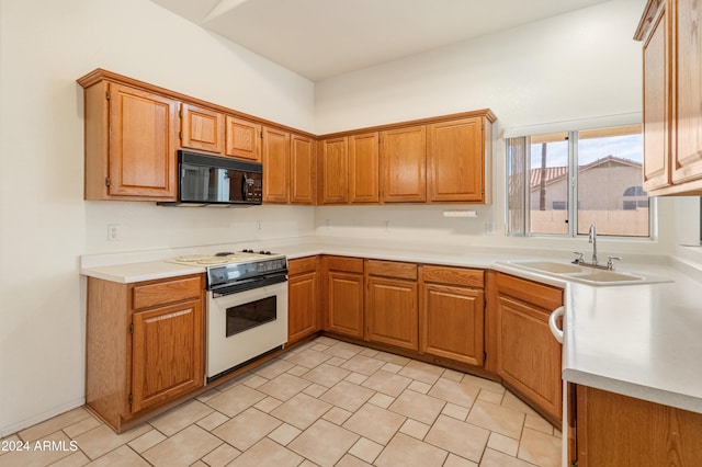 kitchen featuring white range and sink