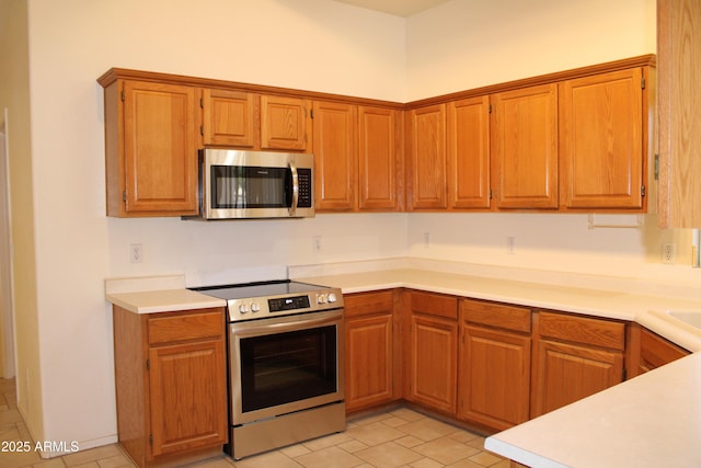 14543 W Bison Path, Surprise, AZ 85374 - kitchen featuring appliances with stainless steel finishes, light countertops, and light tile patterned floors