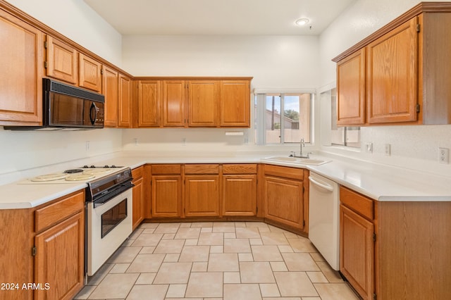 kitchen with light tile patterned flooring, white appliances, and sink