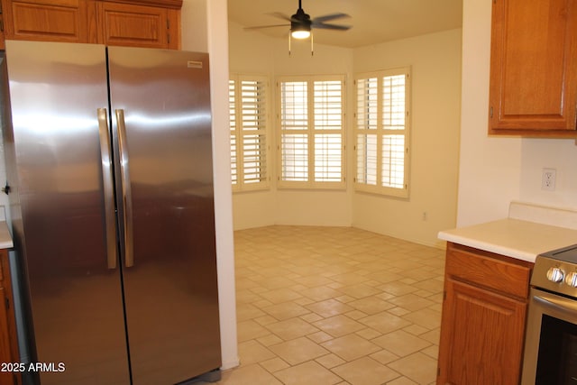 14543 W Bison Path, Surprise, AZ 85374 - kitchen with appliances with stainless steel finishes, a ceiling fan, light countertops, and brown cabinets