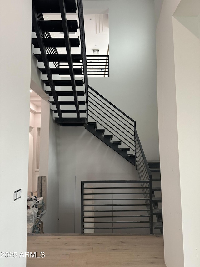 stairway with wood finished floors