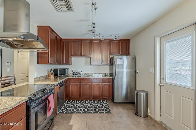 kitchen featuring light stone counters, a sink, visible vents, appliances with stainless steel finishes, and island exhaust hood